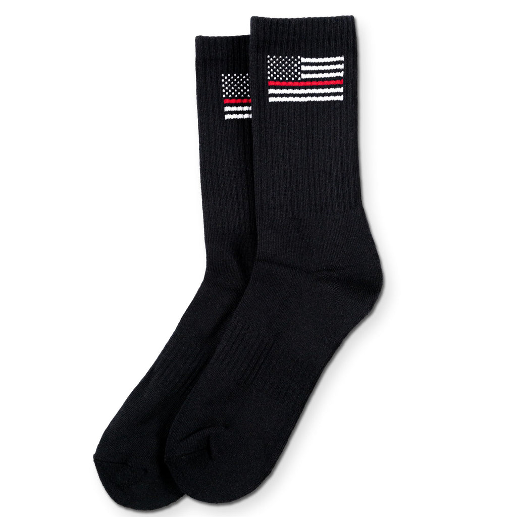 Black socks with thin red line flag design on a white background