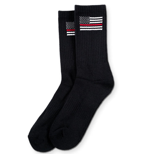 Black socks with thin red line flag design on a white background